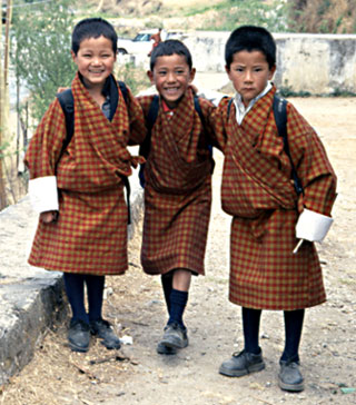 In Bhutan, three young boys on their way to school.